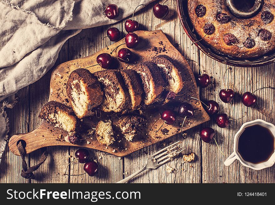 Cake with cheery on wooden table background