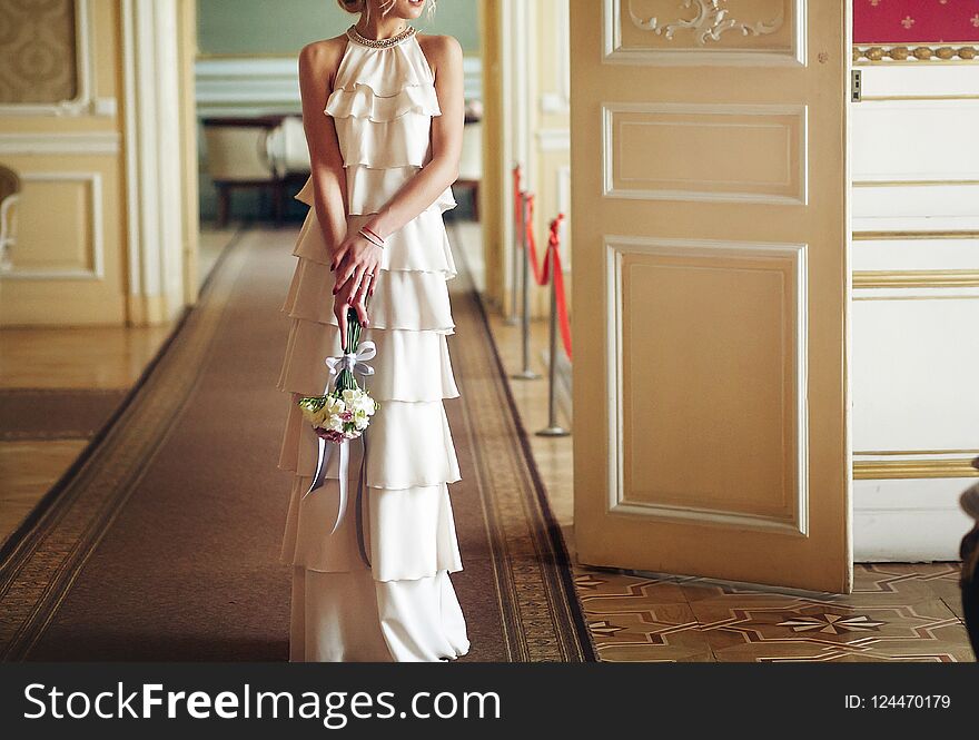 Luxury bride in vintage dress with bouquet posing in luxury hotel room in morning. happy wedding couple, sensual romantic moment in morning