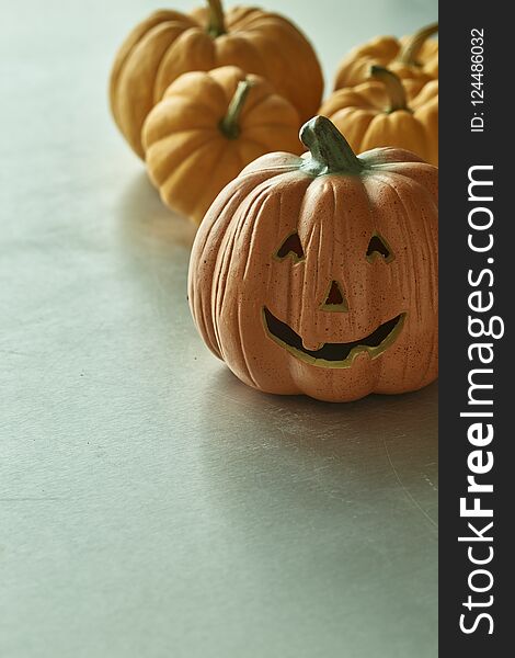 Jack O Lantern And Halloween Pumpkins On Table Back light Nature, copy space. Jack O Lantern And Halloween Pumpkins On Table Back light Nature, copy space