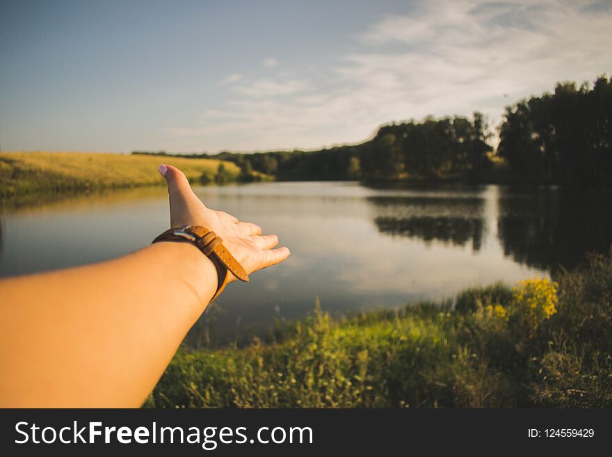 Lake in the forest, beautiful sunset, female hand, the beauty of nature. Lake in the forest, beautiful sunset, female hand, the beauty of nature