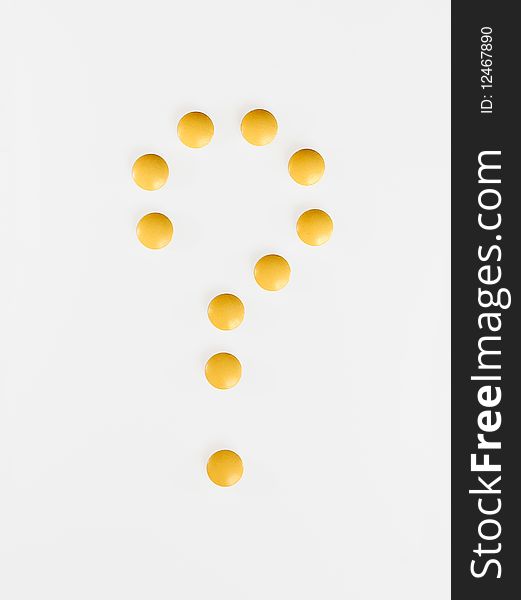 A question-mark made of yellow pills. A question-mark made of yellow pills.