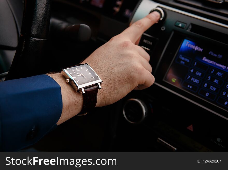 Businessman Driving His Car, Hand On The Steering Wheel. Hand With Golden Watch. Business Concept.