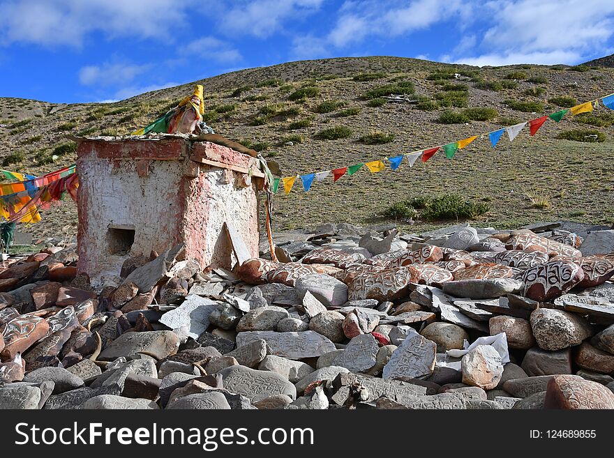 Tibet. Whate stupa and buddhist prayer stones with mantras and ritual drawings on the trail from the town of Dorchen around mount Kailash.