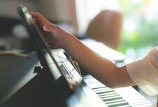 Little Boy Playing With Piano And Music Tablet At Home Stock Photography