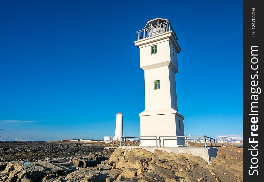 The old inactive Arkranes lighthouse at end of peninsula, was built since 1918, under blue sky, Iceland. The old inactive Arkranes lighthouse at end of peninsula, was built since 1918, under blue sky, Iceland