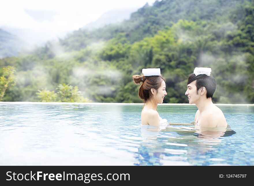 Young asian couple relaxing in hot springs