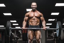 Brutal Strong Bodybuilder Athletic Men Pumping Up Muscles With D Royalty Free Stock Photos