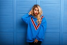 Young Stylish Woman In Blue Fashion Clothes Near A Wooden Wall. Stock Images Young Stylish Woman In Blue Fashion Clothes Near A Wooden Wall. Stock Images