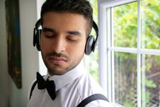 CEO, Businessman Wearing Tuxedo Listens To Headphones With Closed Eyes Royalty Free Stock Image