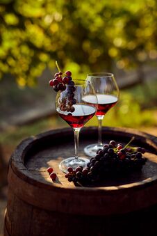 Two Glasses Of Red Wine With A Bottle On A Wooden Barrel Royalty Free Stock Photography