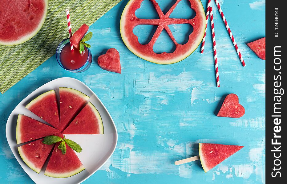 Watermelon slices and hearts in blue wooden background