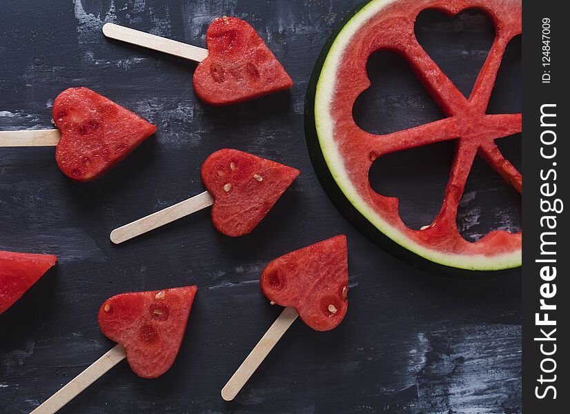 Cute heart pieces of fresh watermelon in black background