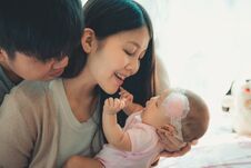 Closeup Portrait Of Happy Family With Little Baby On The Bedroom Royalty Free Stock Images