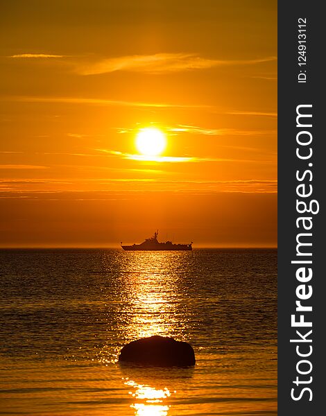 Wonderful landscape with a ship in the sea at sunset.