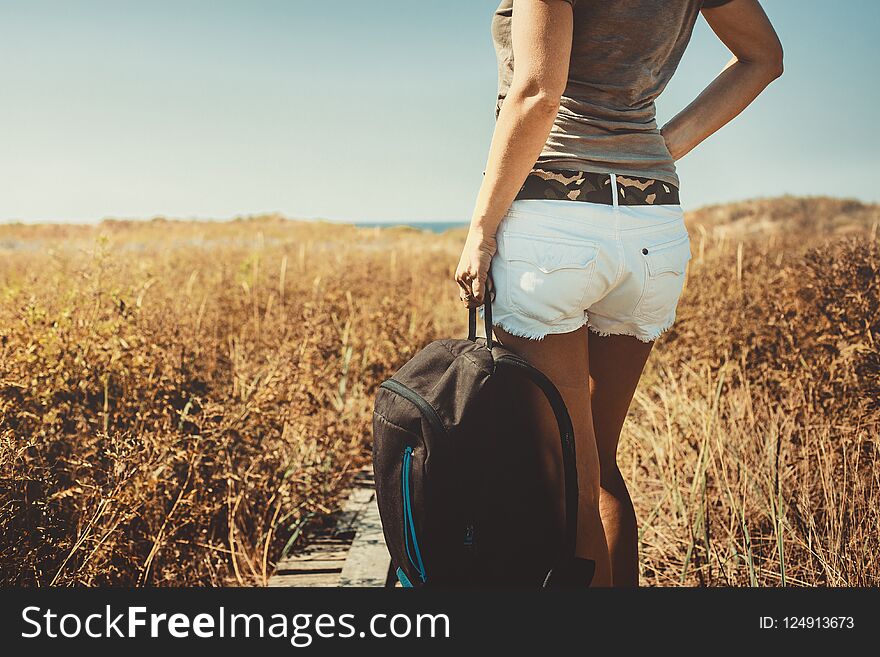 Unrecognizable girl traveler with a backpack In Summer, Rear Vie