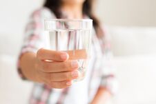 Happy Beautiful Young Woman Holding Drinking Water Glass In Her Royalty Free Stock Photography