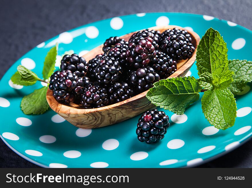 Ripe Blackberries With Leaves Of Mint In A Bowl On A Wooden Boar