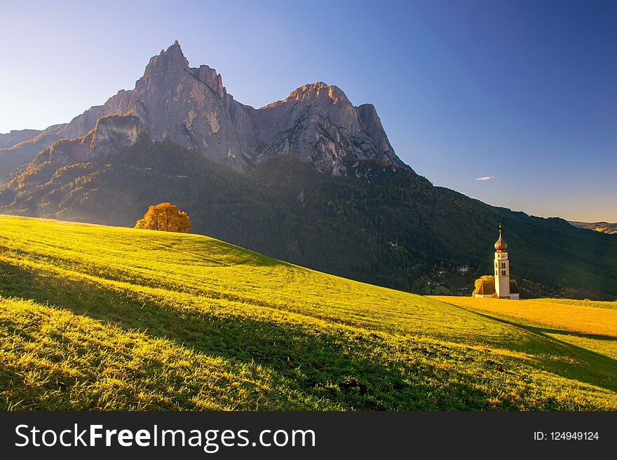 Traditional Tyrol Church In The Foothills Of The Dolomites Under Autumn Sun