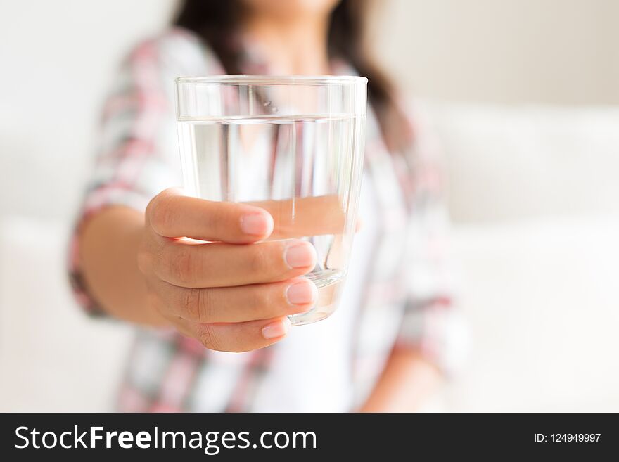 Happy Beautiful Young Woman Holding Drinking Water Glass In Her