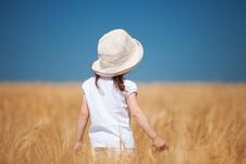 Happy Girl Walking In Golden Wheat Stock Photography
