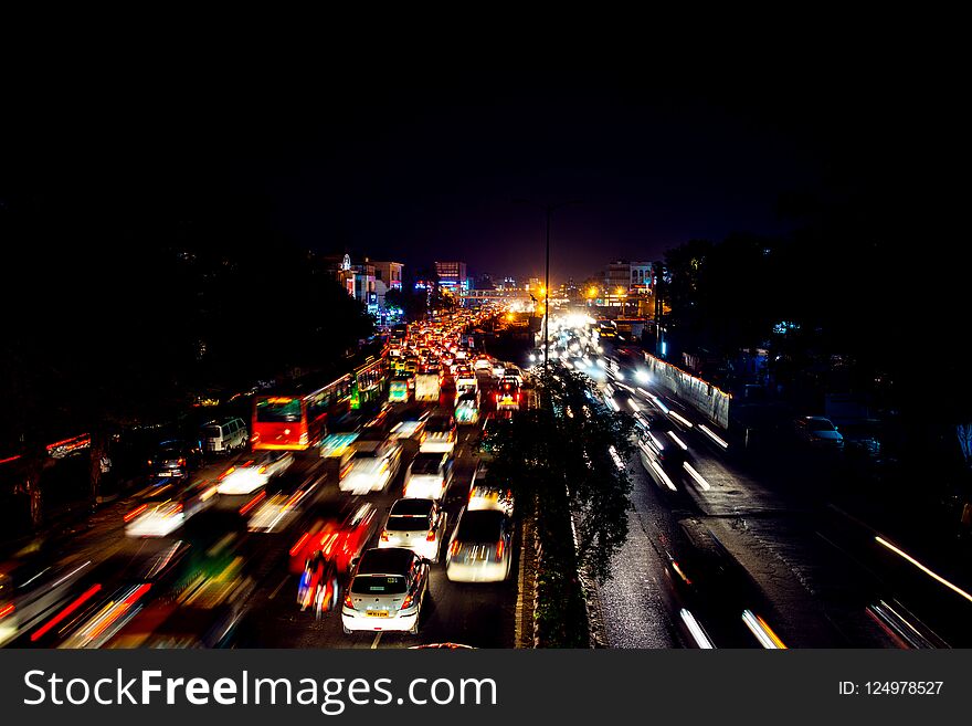 Heavy car traffic in the city center of Delhi, India at night