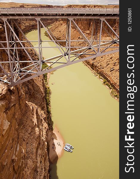 Raft trip on the Colorado River takes a lunch break under the Navajo Bridge