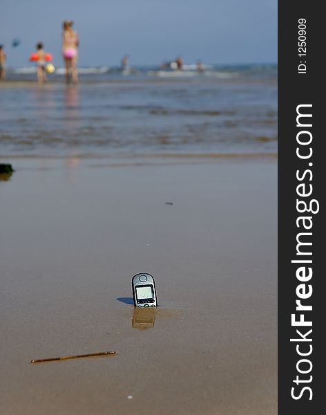 A Cell-Phone left on the beach. A Cell-Phone left on the beach