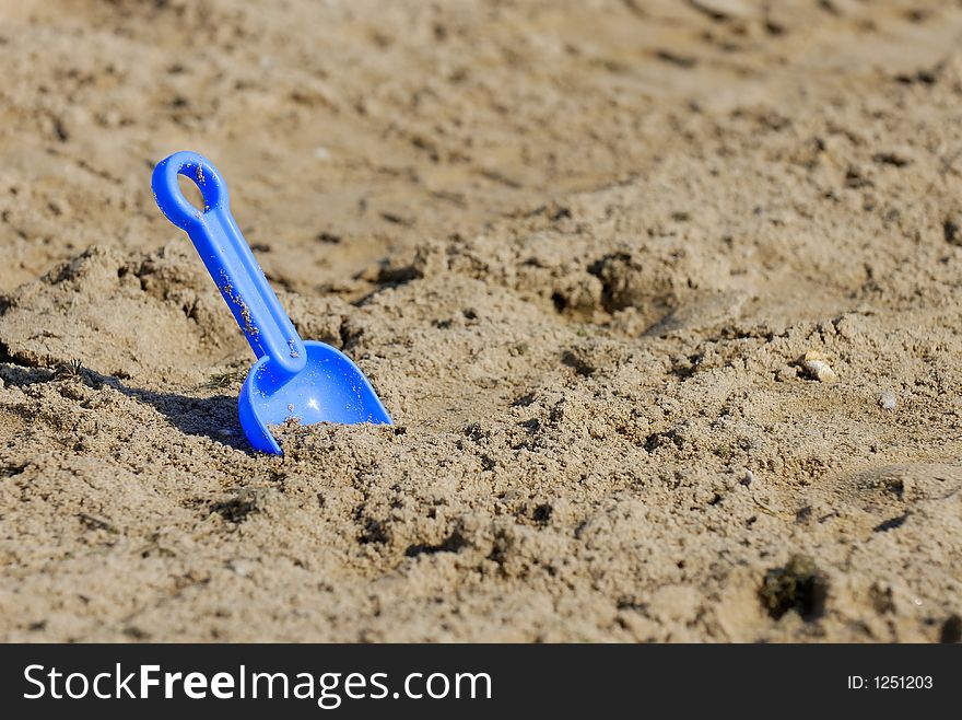 Blue Spade stucking in sand. Blue Spade stucking in sand