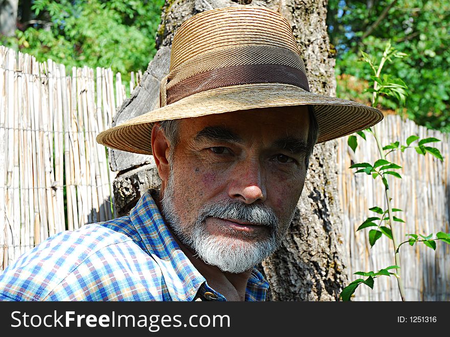 Bearded senior with a straw hat