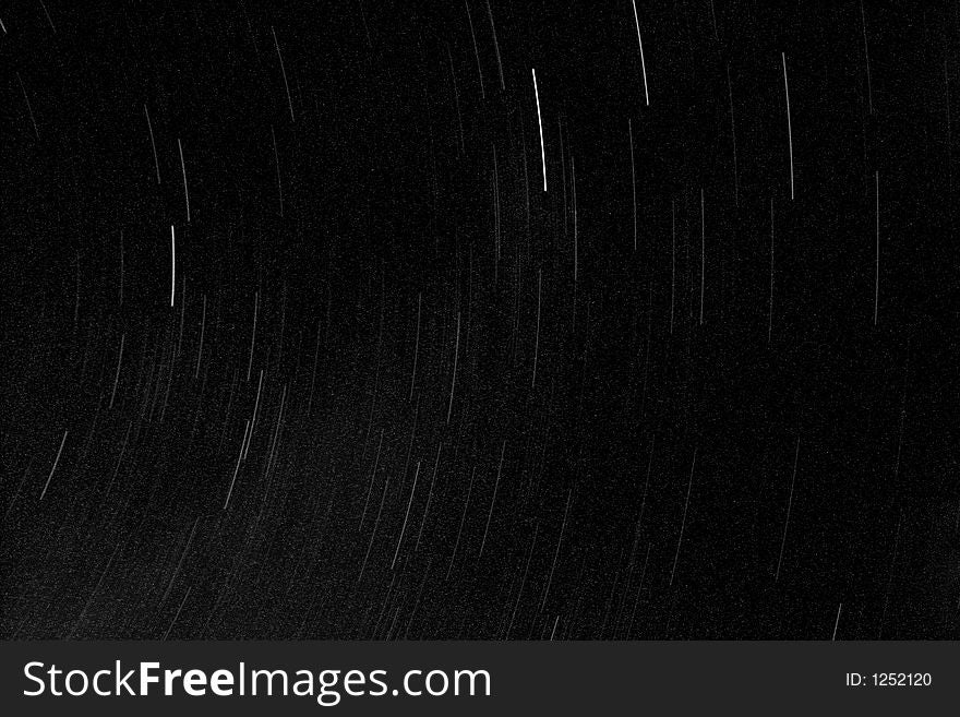 Abstract black background with star trails made with a 30 minute exposure