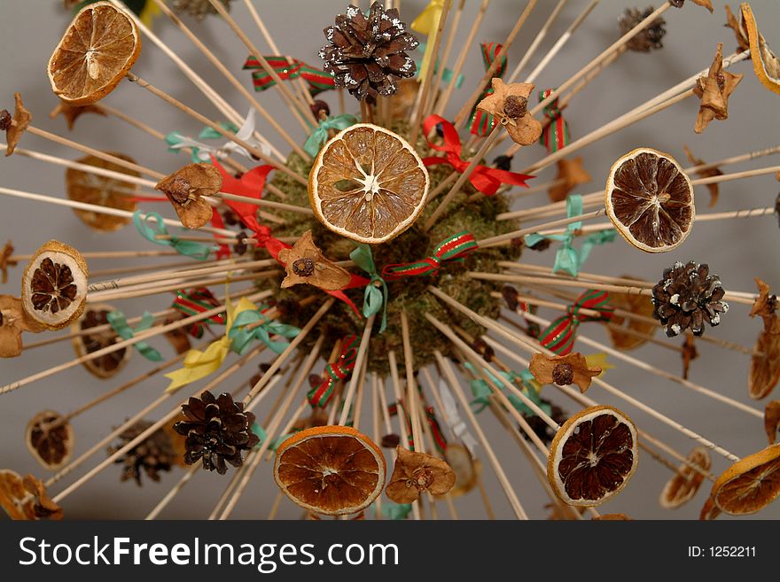 Christmasball made of citrus fruits and pine cones