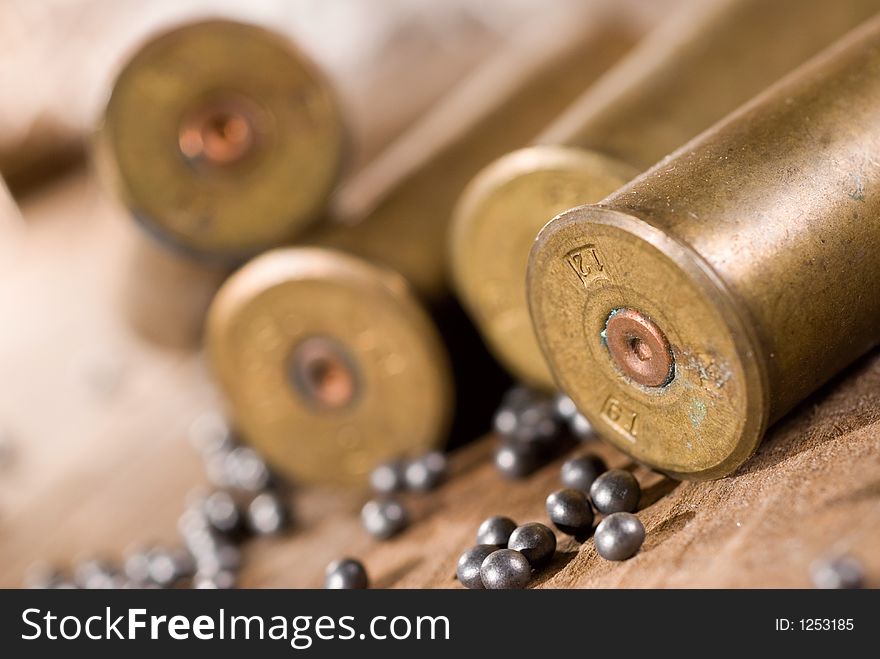 Shotgun shells and shot on wood background. Shotgun shells and shot on wood background
