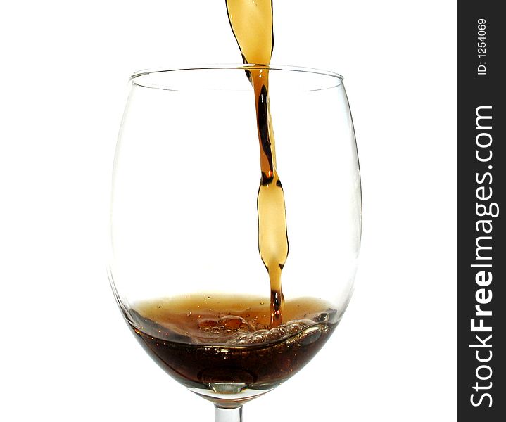 Regular cola poured in a wine glass. Regular cola poured in a wine glass