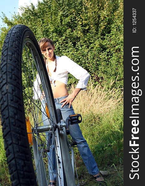 A Girl with her bicycle - posing outdoor. A Girl with her bicycle - posing outdoor