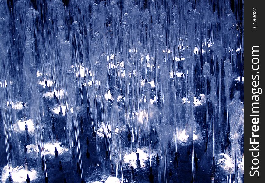 Detail on the fountain at night in blue light