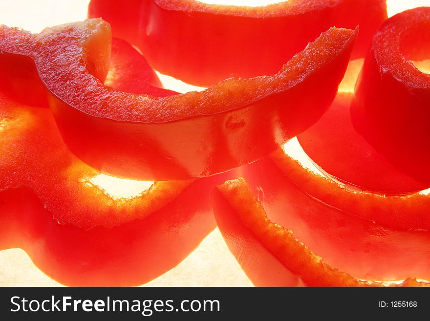 Slices of red pepper with white background. Slices of red pepper with white background