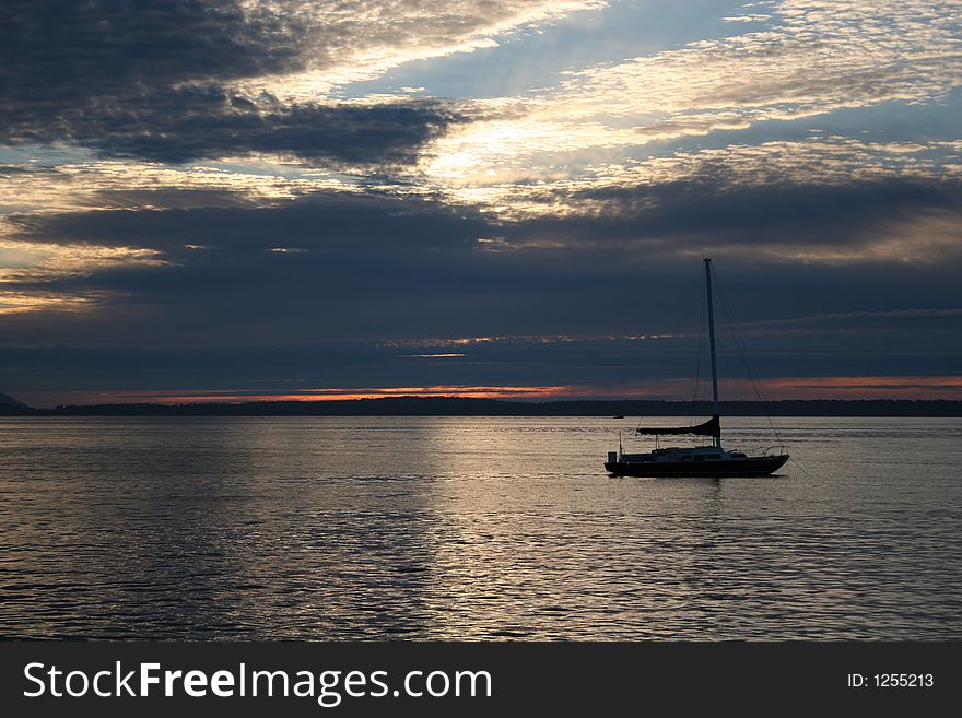 Sillouette of sailboat against sunset in Puget Sound. Sillouette of sailboat against sunset in Puget Sound