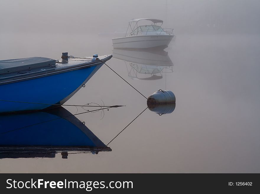 An early morning shot of boats anchored in the Great Egg Harbor River in the fog. An early morning shot of boats anchored in the Great Egg Harbor River in the fog