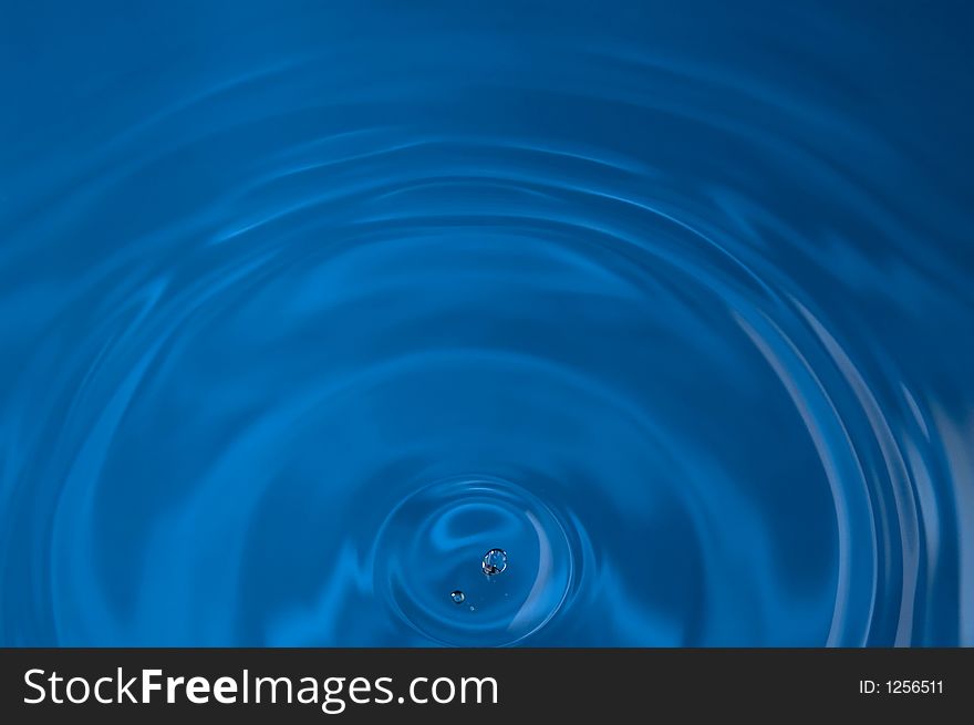 Drop of water above rippled water. Drop of water above rippled water