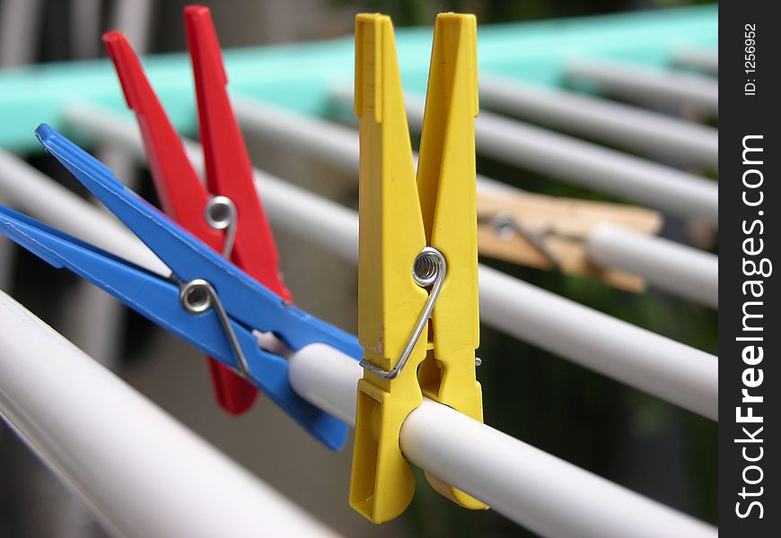 Some colored clothes pegs on a clothes line