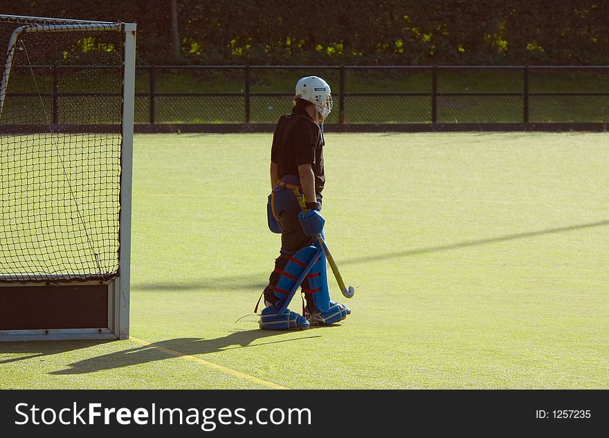 Hockey goalkeeper on a green field
