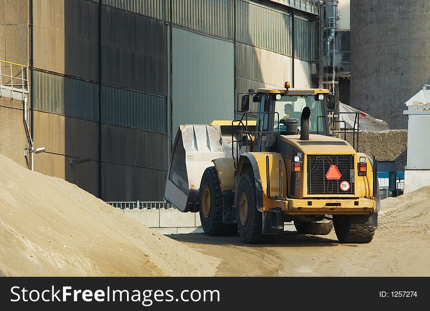 A yellow bulldozer in action