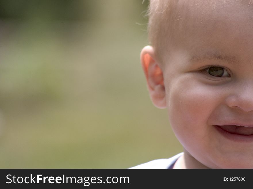 Half baby boy's face out of the right side of the frame. Half baby boy's face out of the right side of the frame