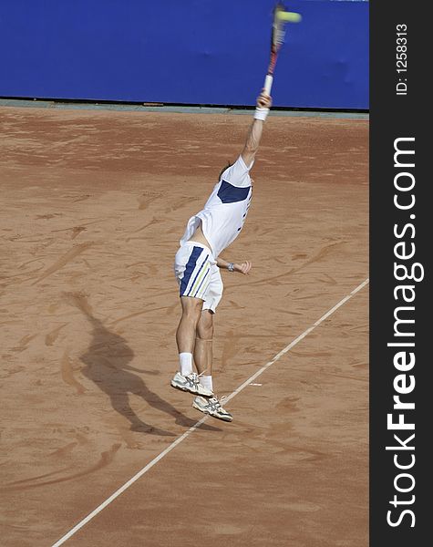 Tennis man with tennis racket serving the ball on the tennis court. Tennis man with tennis racket serving the ball on the tennis court