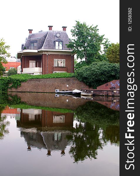 A House by the river side and its reflection. A House by the river side and its reflection