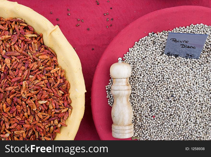 Spices on a table with pepper grinder