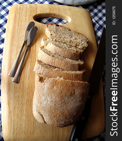 Tradicional bread, sliced on a wooden plate. Tradicional bread, sliced on a wooden plate.