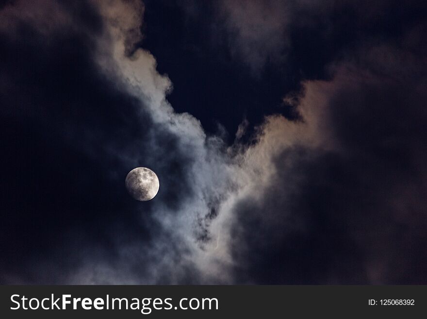Full moon in the middle of clouds