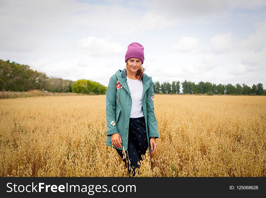 Outdoor atmospheric lifestyle photo of young beautiful darkhaired woman in knitting hat in sunny autumn day