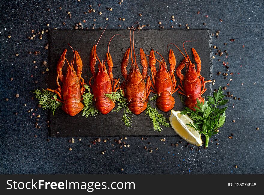 Boiled cooked crayfish crawfish ready to eat on black background